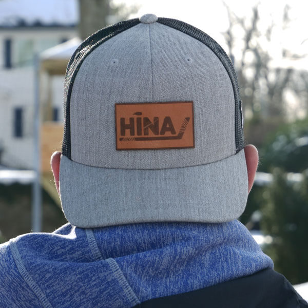 Man wearing HINA baseball cap