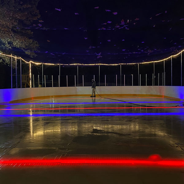 ice rink at night with custom lights under ice