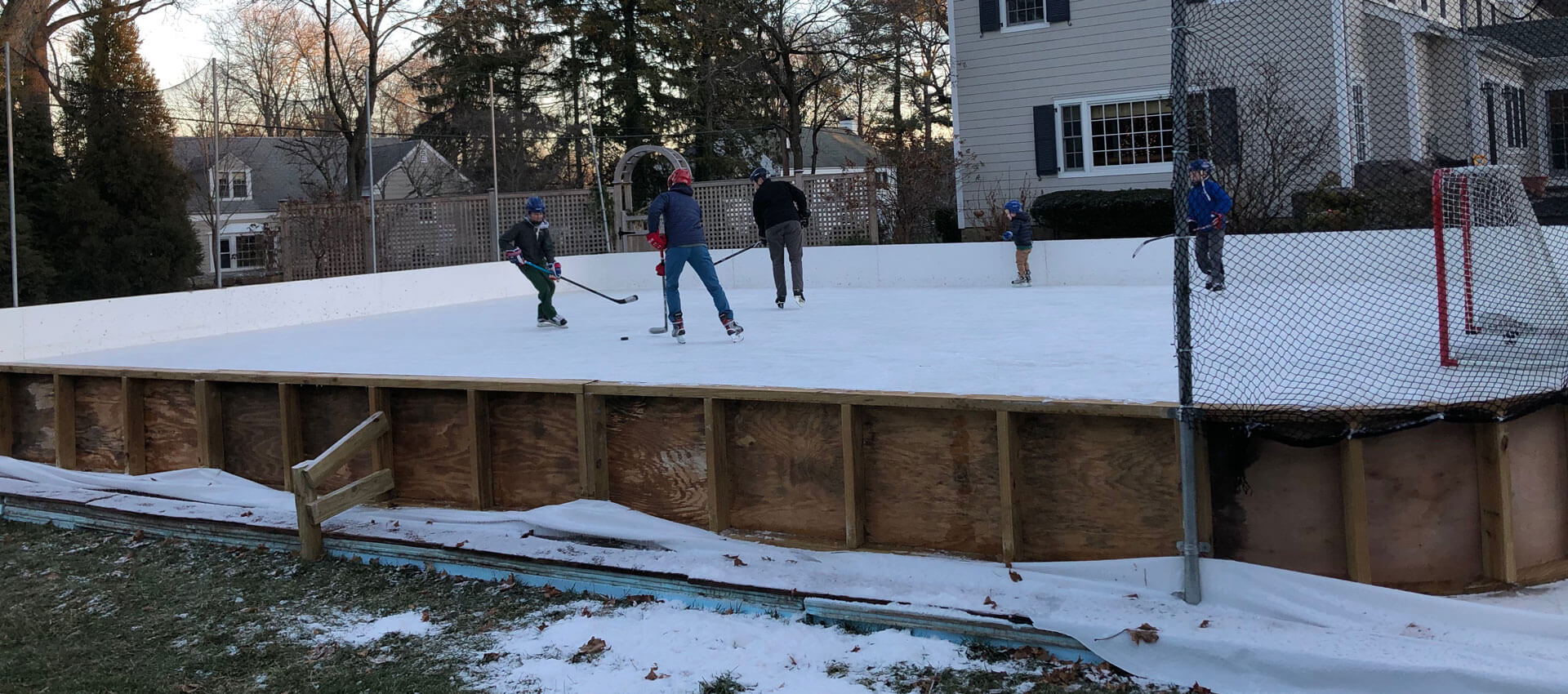 family skating on ice rink